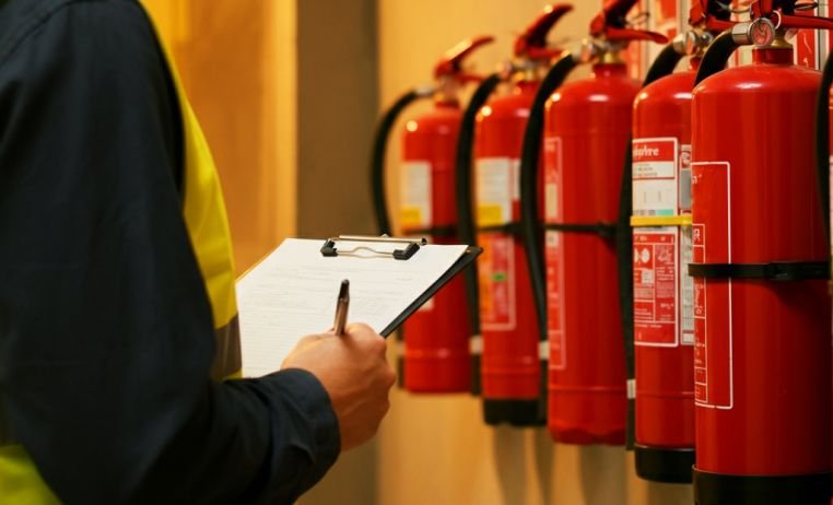 Thorough fire safety inspections for premises compliance Fire safety consultant doing comprehensive fire safety inspection UK