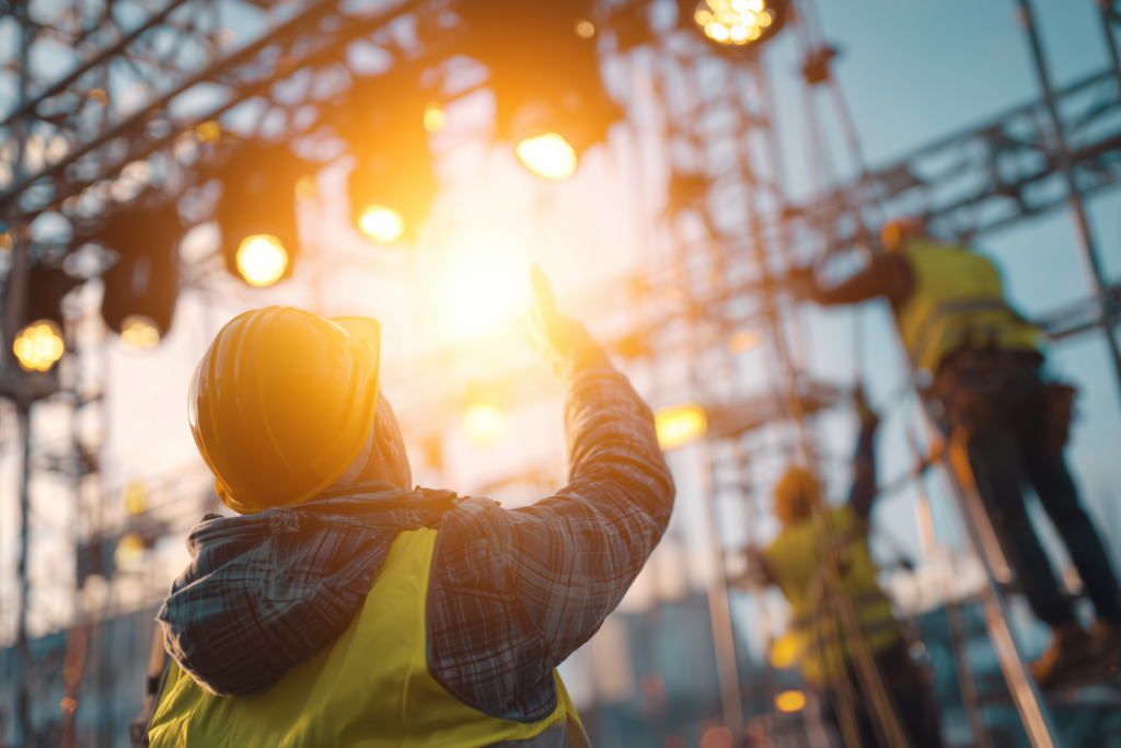 Health and safety advisor supervising workers at height during sound stage construction